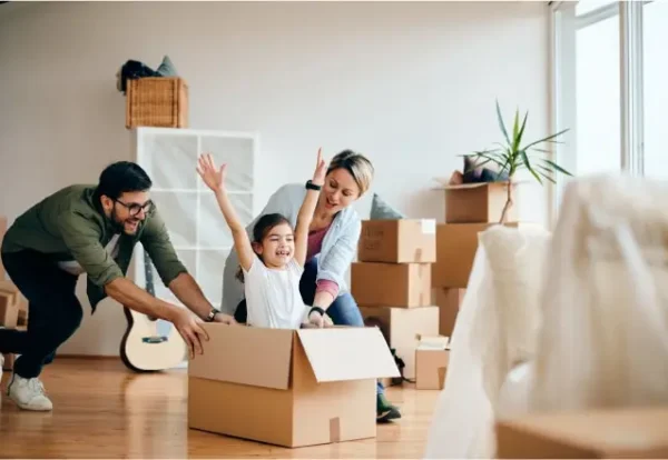 carefree-family-having-fun-while-moving-into-new-home